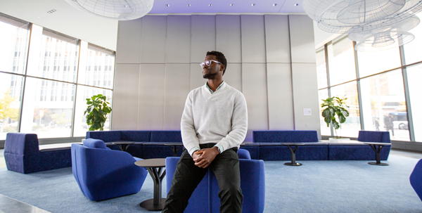Photo of Odaro sitting in a modern office space